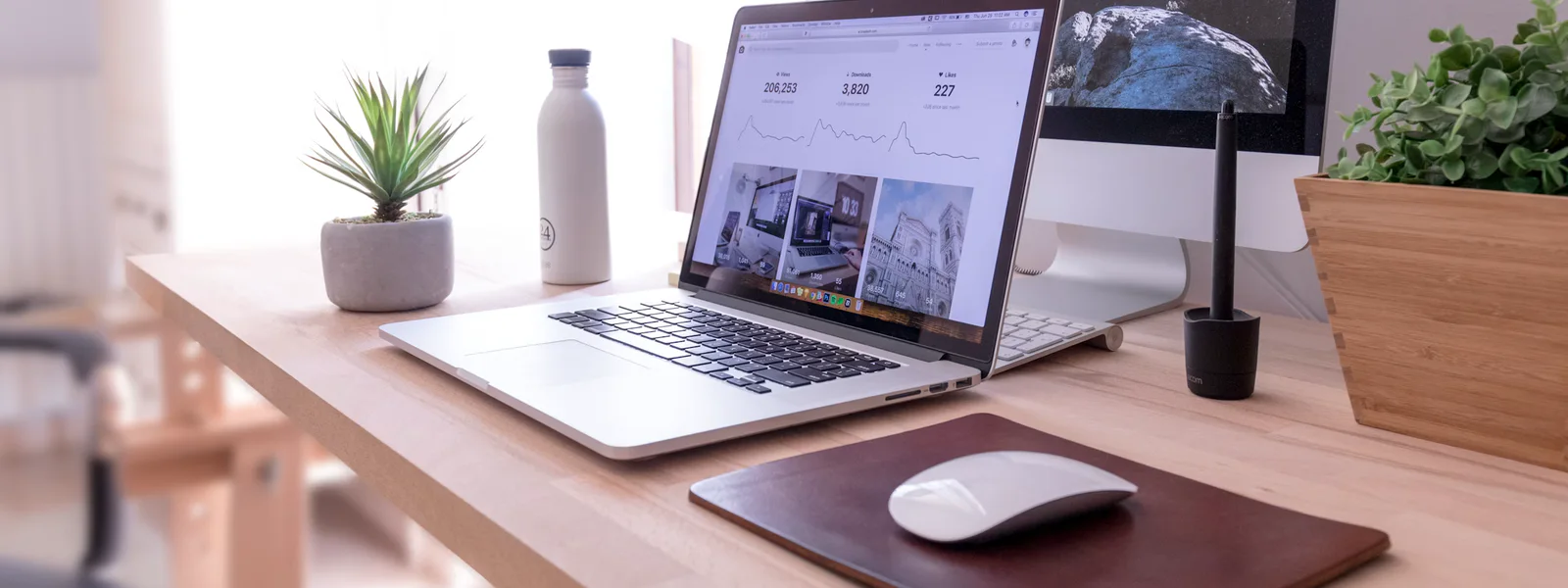 Software review workstation with laptop, desktop display, and desk tools